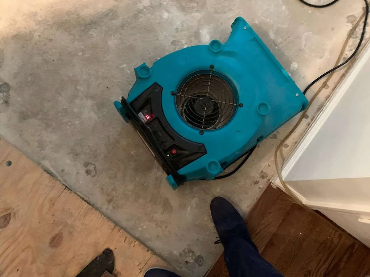 Air mover drying subfloor during Commercial Water Damage Restoration in Hallandale Beach